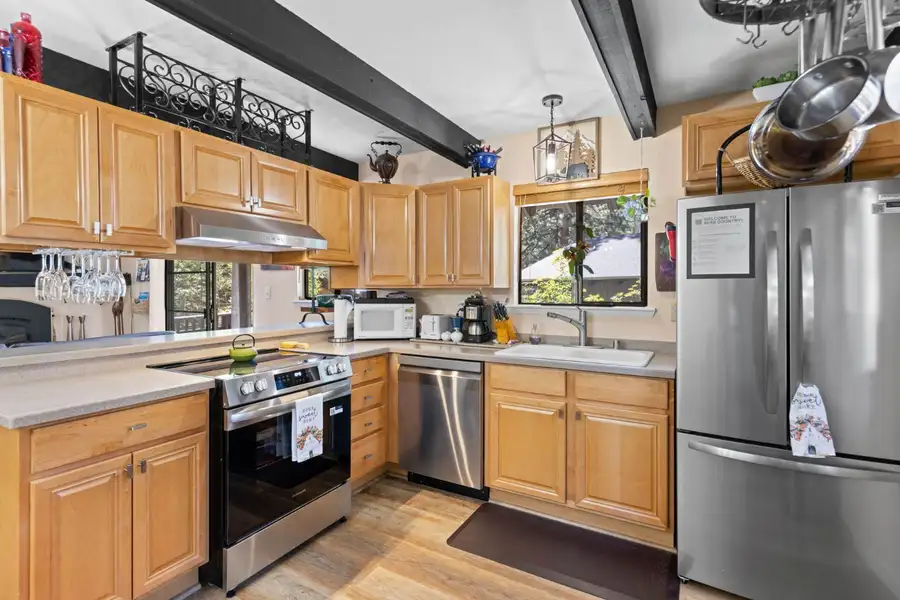 Kitchen with wood cabinets and stainless appliances, Cortina Chalet