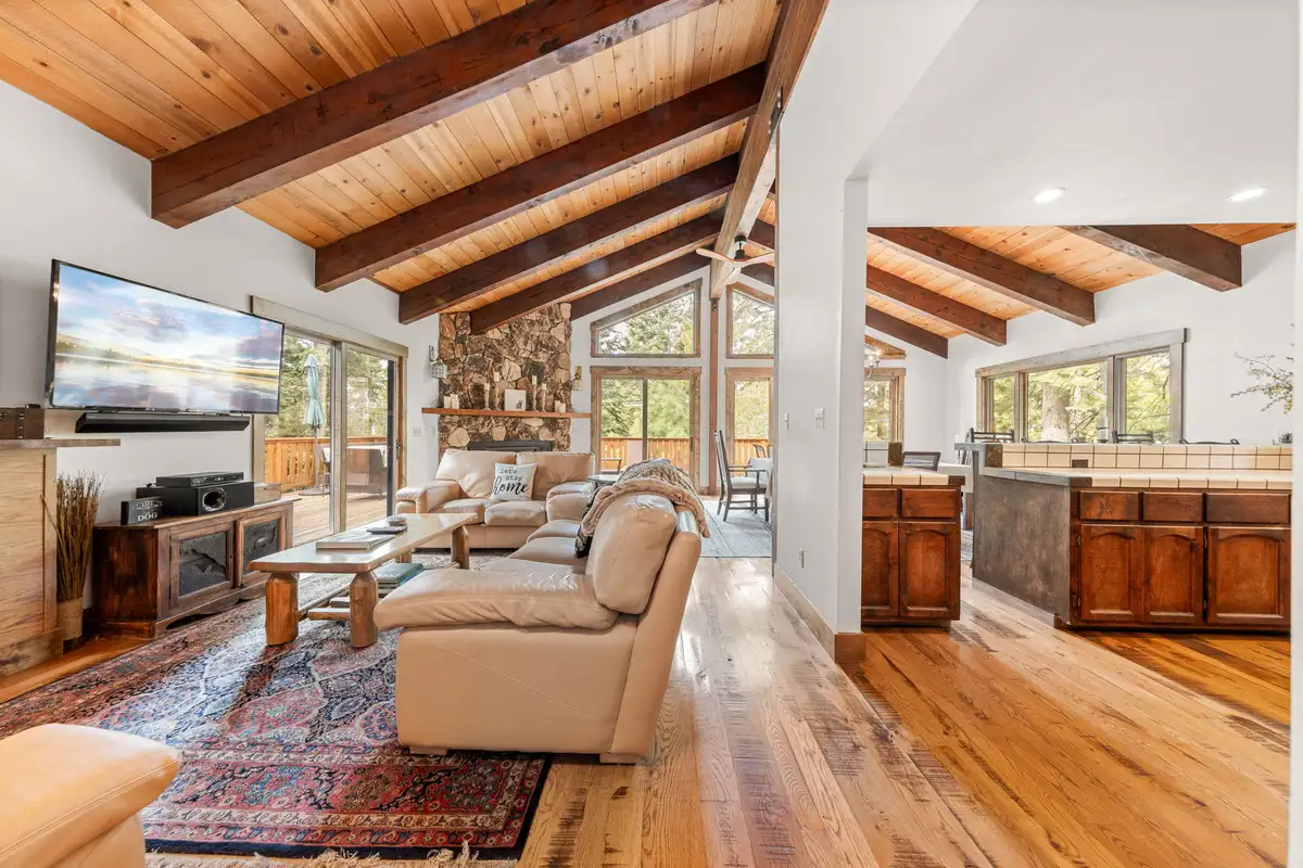 Living room with leather sofas and stone fireplace, Evergreen Hideout