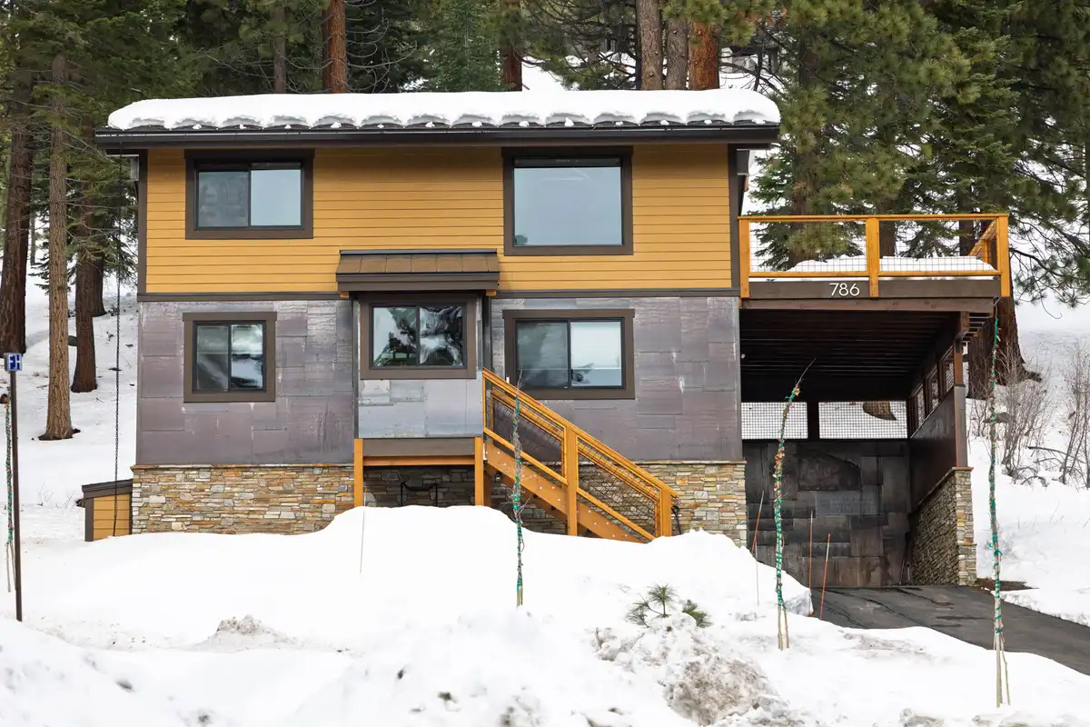 Two-story home exterior in deep snow, Sugar Pine Tahoe Lodge