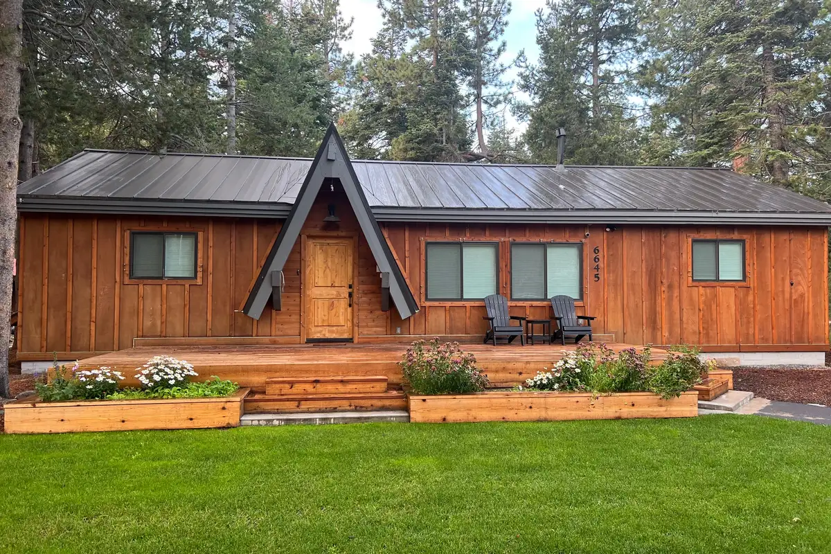 Single-story wood cabin with A-frame entry and green lawn, Updated West Shore Cabin 1 mile to Chambers Beach