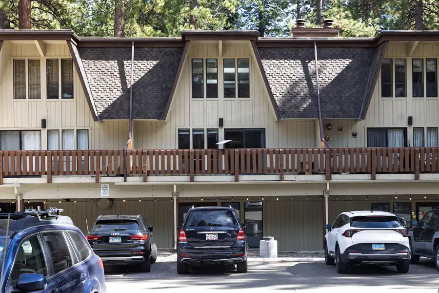 Exterior view of the A-frame townhome with balcony and garage parking, Treetop on Country Club