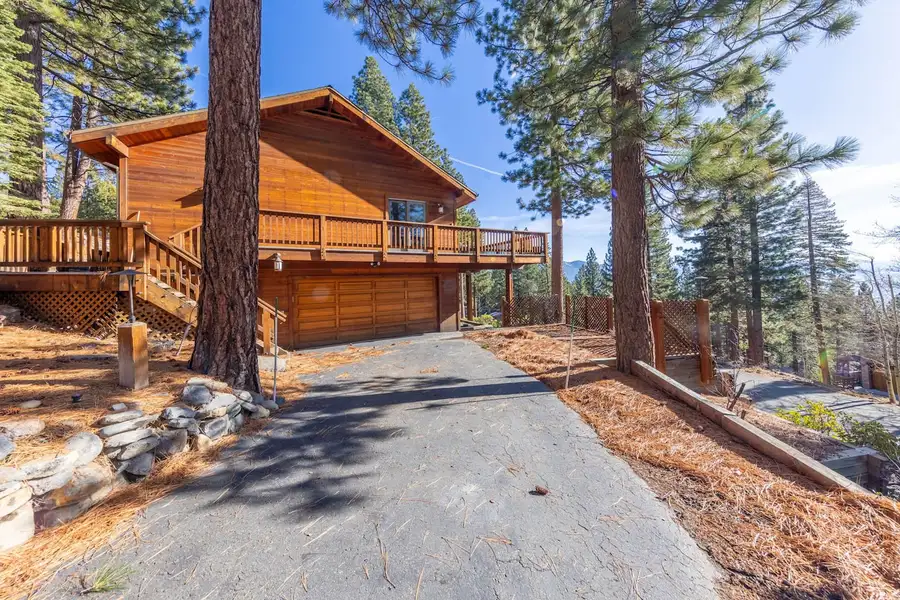 Wood home with a wraparound deck above the garage, Tranquil Alpine Bliss