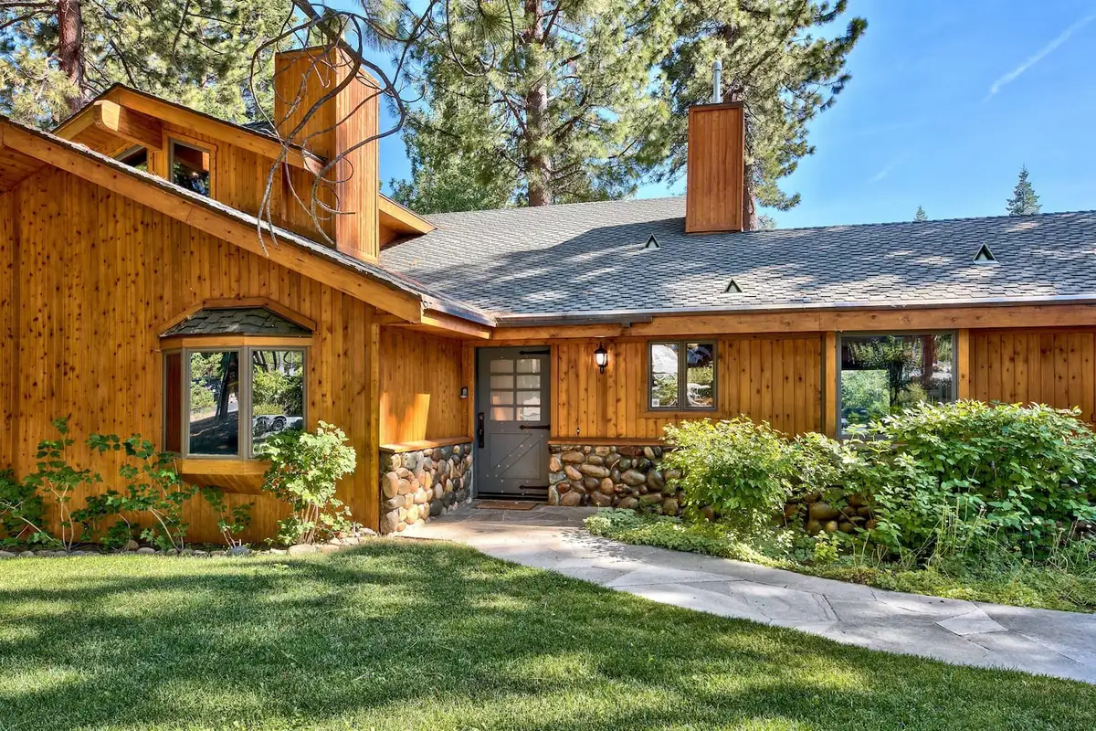 Wood-sided home with a green lawn and stone accents, Mammoth Haven Retreat