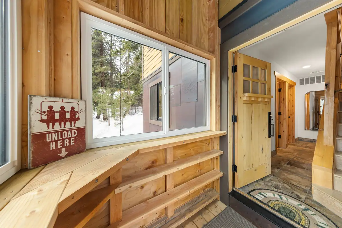 Entryway with wood-paneled walls and a window bench, Sugar Pine Tahoe Lodge