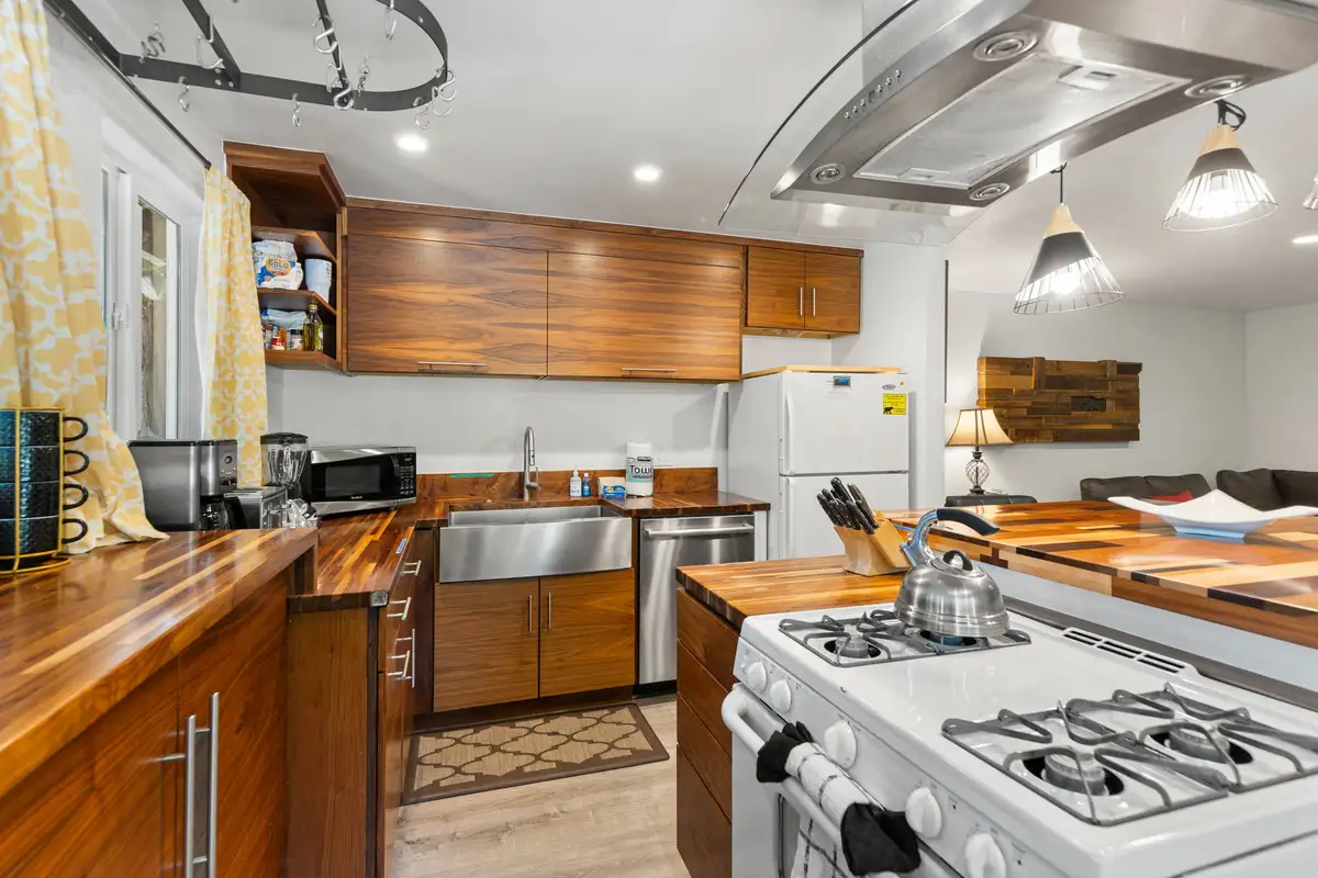 Kitchen with a white gas range and wood cabinets, Tahoe Lake & Mountain Retreat