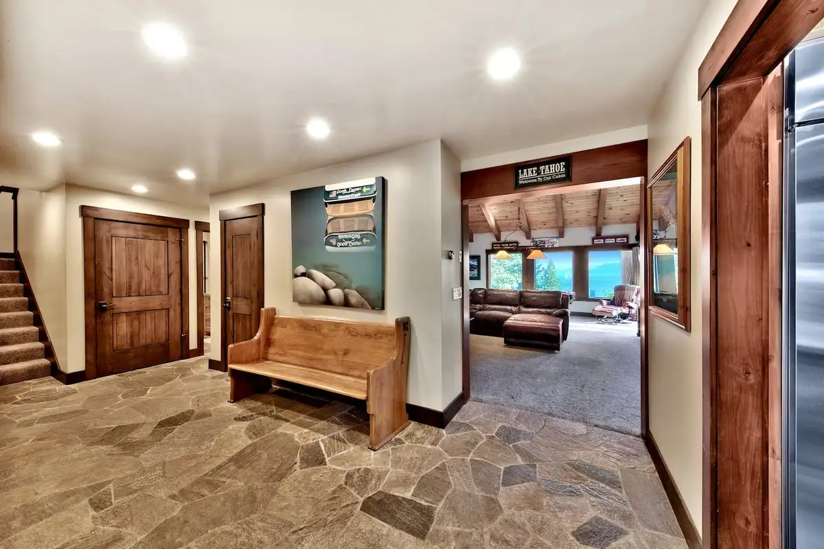 Slate-floored entry with bench and wood doors, Mammoth Haven Retreat