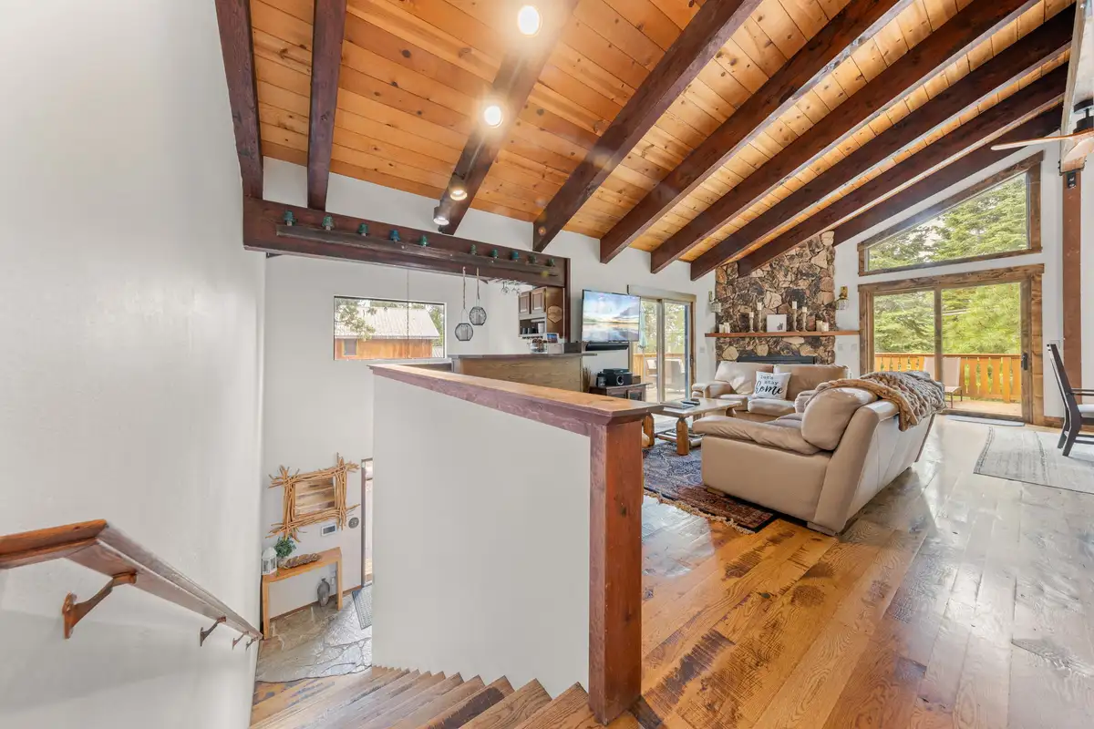 Open living area seen from the stairs with wood beams, Evergreen Hideout