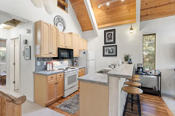 Kitchen with light wood cabinets and breakfast bar, Serenity Bungalow
