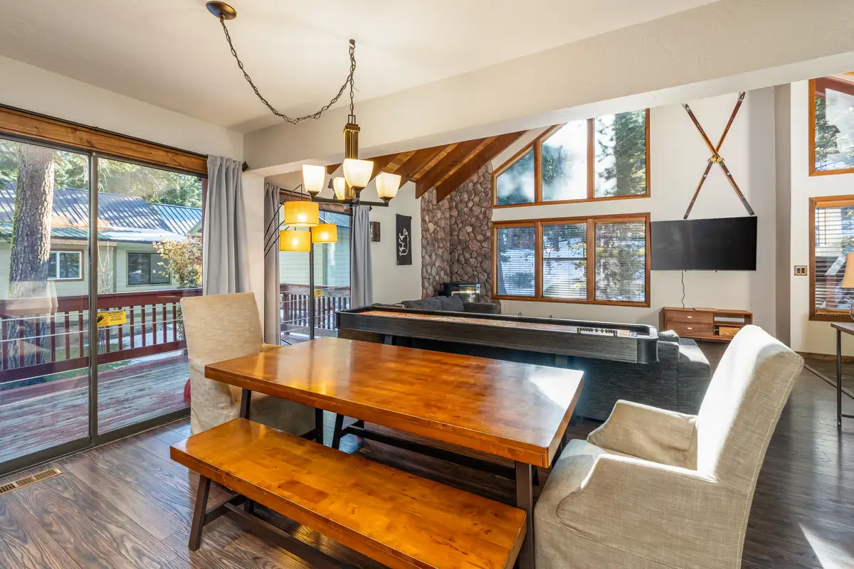 Dining table with benches next to a shuffleboard table, Grand Regency Retreat