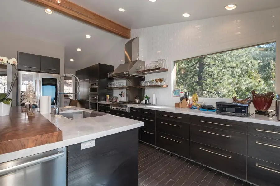 Kitchen with white counters, dark cabinets and range hood, Skylake Serenity Retreat