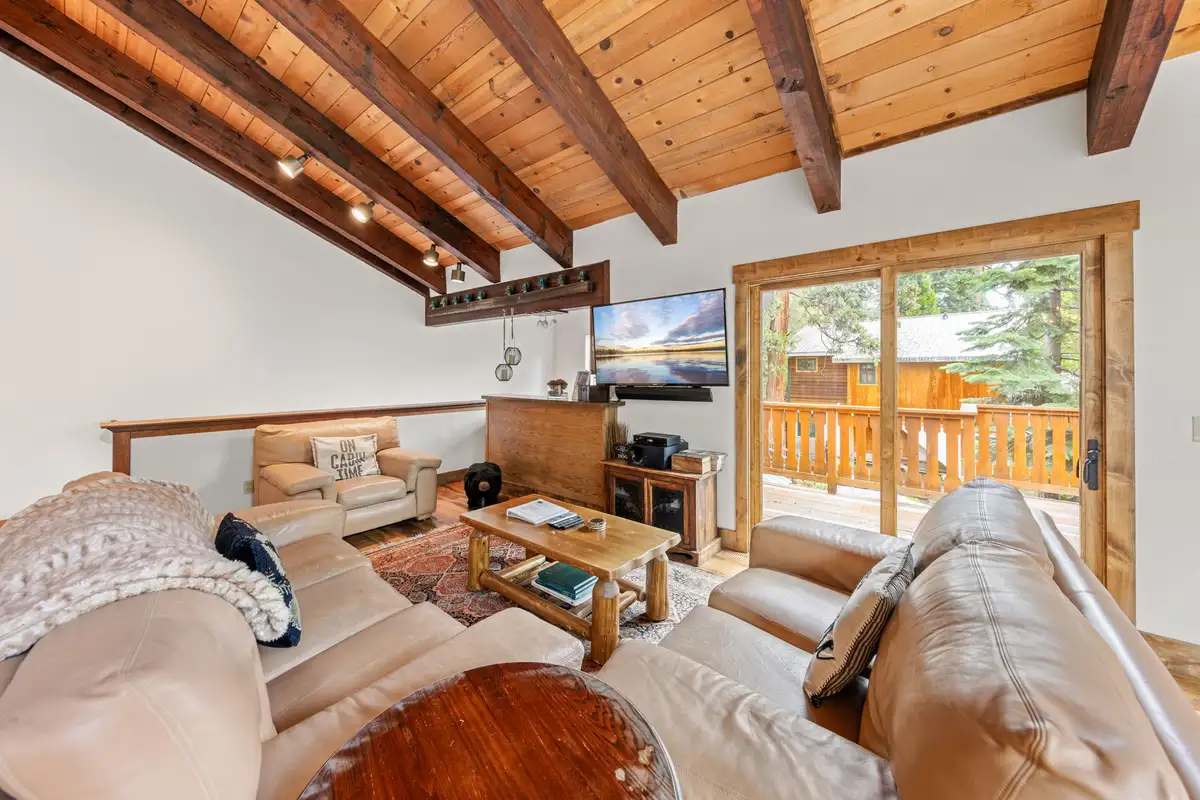 Living room with leather sofas and sliding doors to a deck, Evergreen Hideout