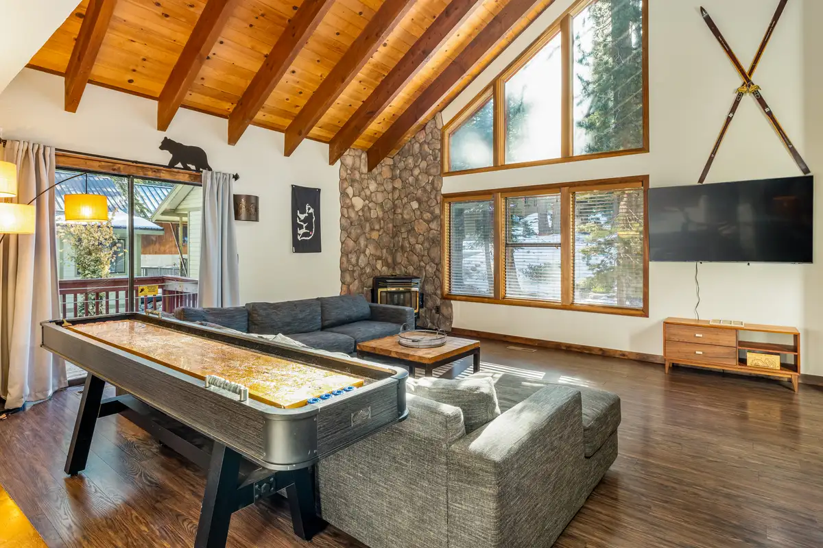 Living room with shuffleboard table and vaulted wood ceiling, Grand Regency Retreat