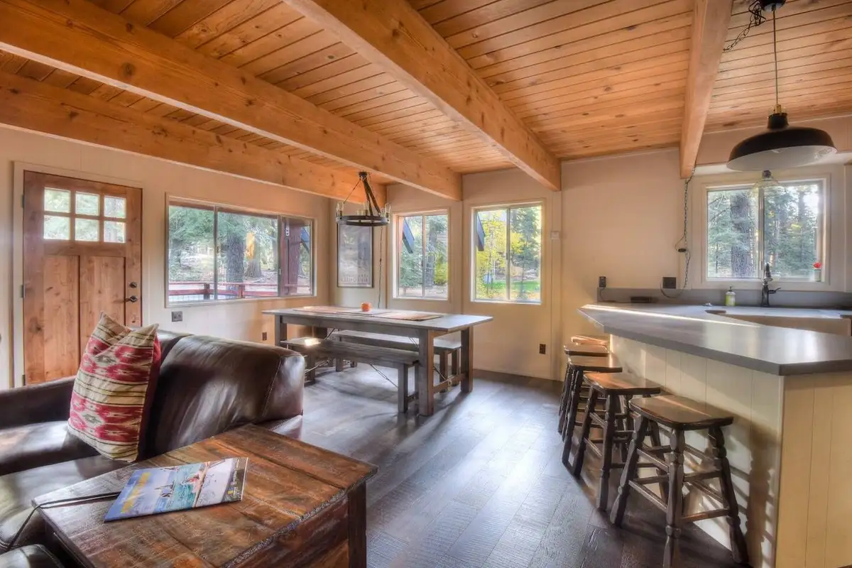 Open living area with a breakfast bar and dining table, Enchanting Chamberlands Cabin