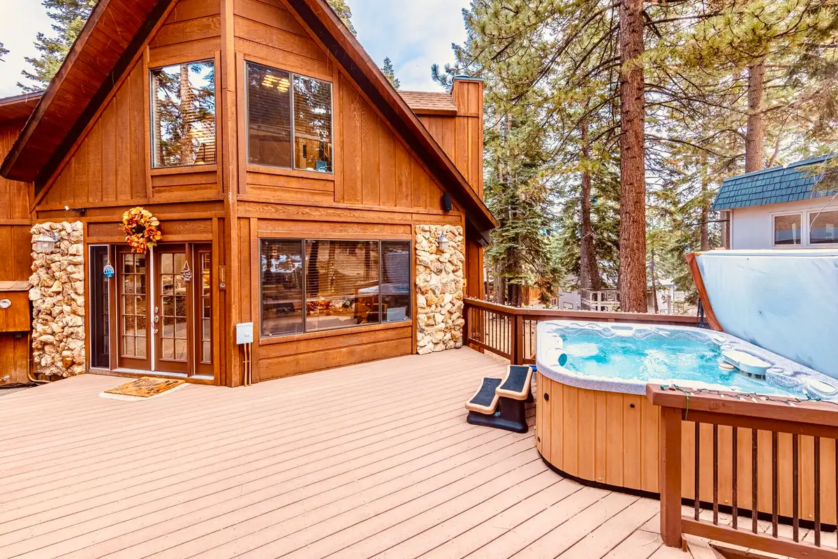 Deck with an open hot tub beside a wood A-frame, Sunlit Incline Retreat
