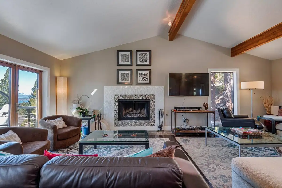 a warm living room for the family to watch sports, shows, or movies on the comfortable couch next to the fireplace, Skylake Serenity Retreat