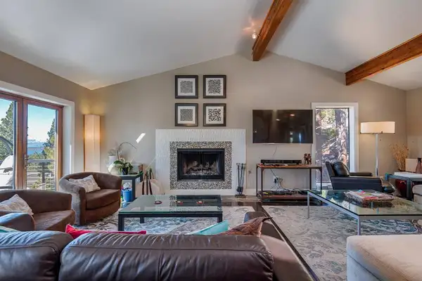 a warm living room for the family to watch sports, shows, or movies on the comfortable couch next to the fireplace, Skylake Serenity Retreat