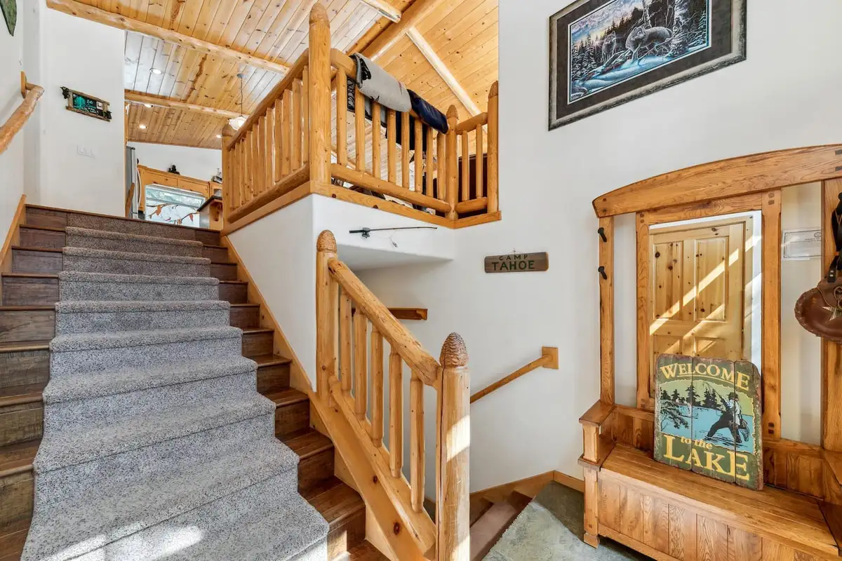 Entry stairway with log railings and a welcome sign, Hastings Hideaway Cabin