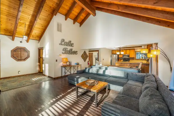 Living room with gray sectional and kitchen beyond, Grand Regency Retreat