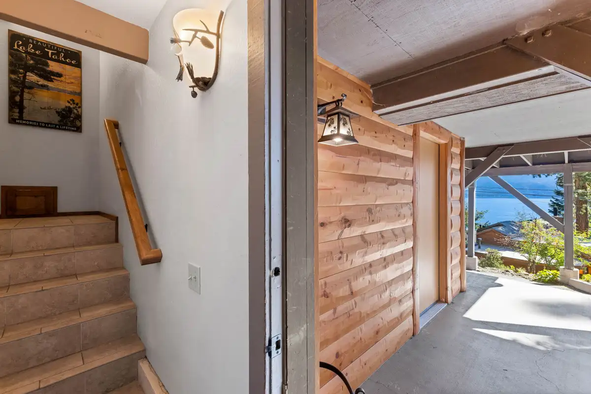 Stairway beside a doorway with a lake glimpse, Livin' on the Edge