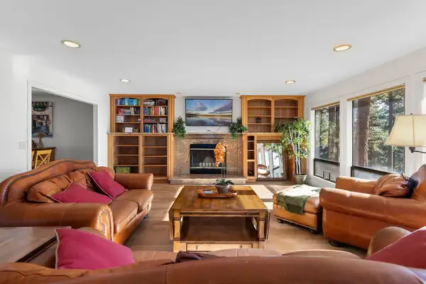 Living room with leather sofas, fireplace and built-in bookshelves, Tranquil Alpine Bliss
