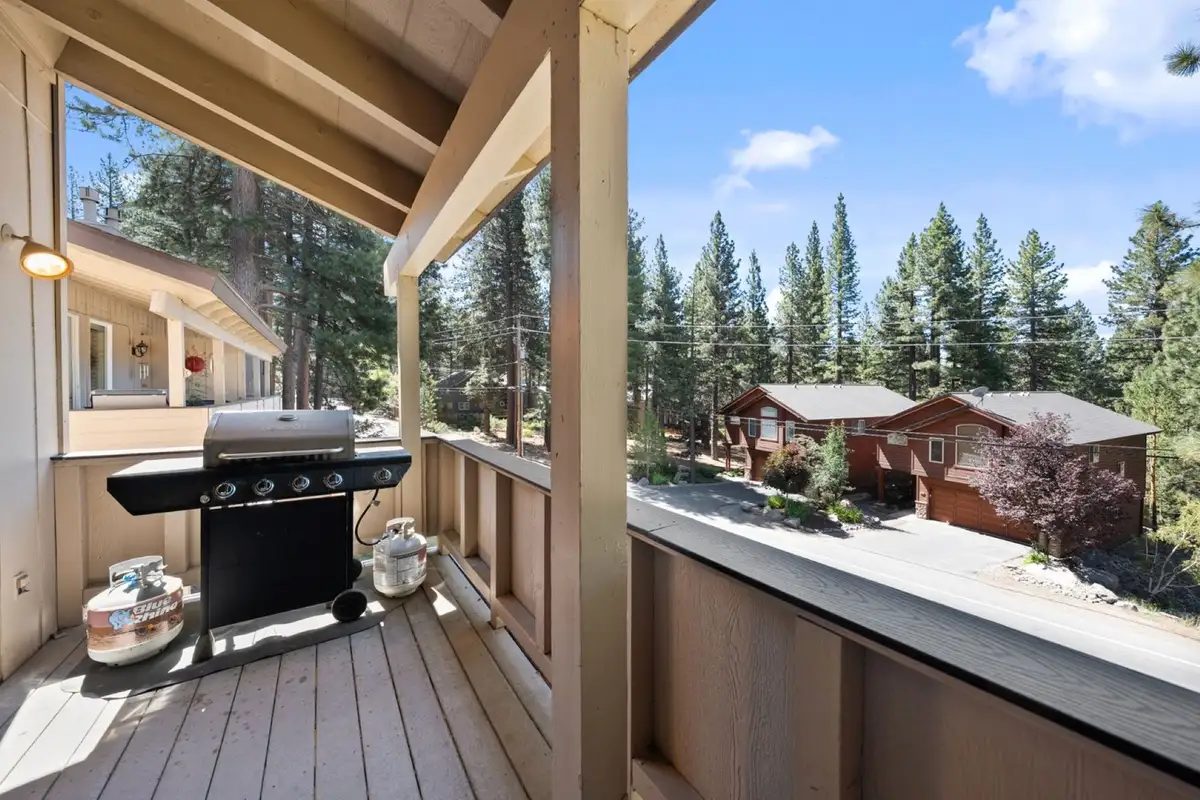 Covered balcony with a grill overlooking the street, Skiway Suite