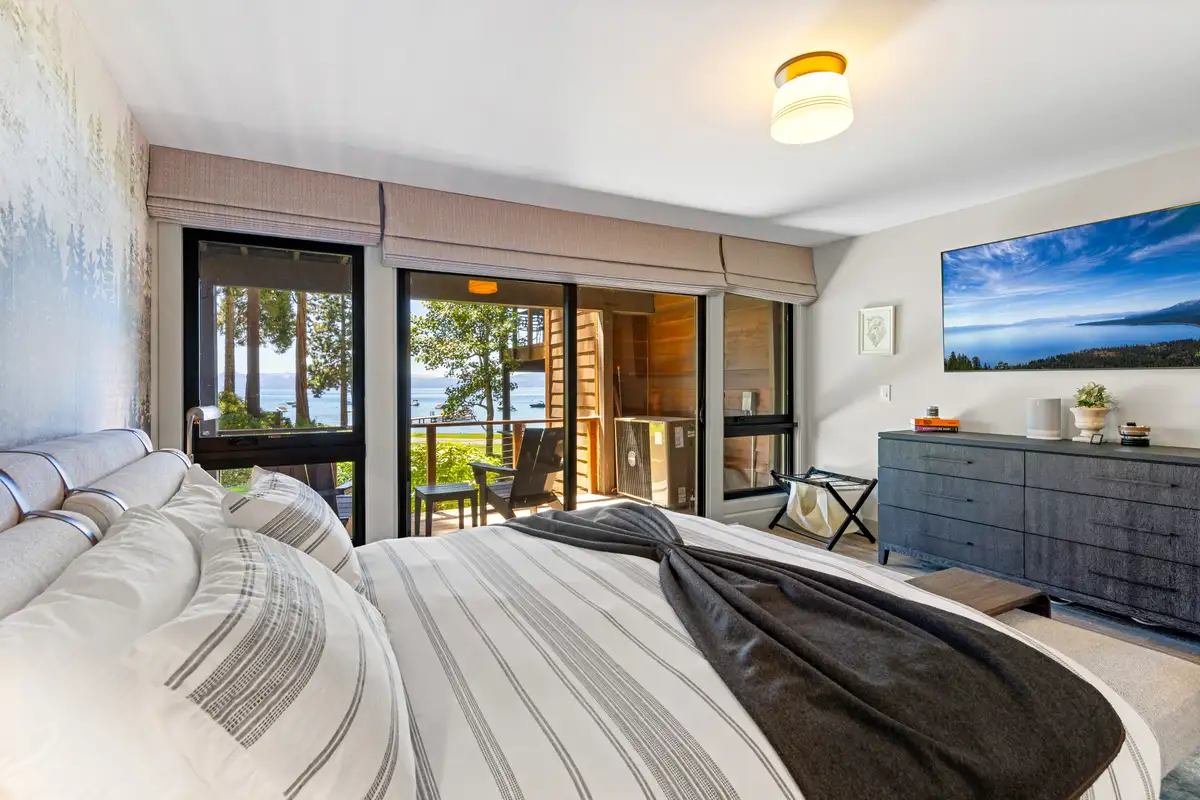 Bedroom with a bed and Lake Tahoe visible through the windows, Lakeside Luxe Retreat