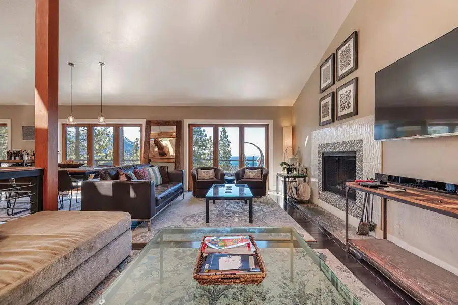 Living room with a fireplace, wall TV and glass coffee table, Skylake Serenity Retreat