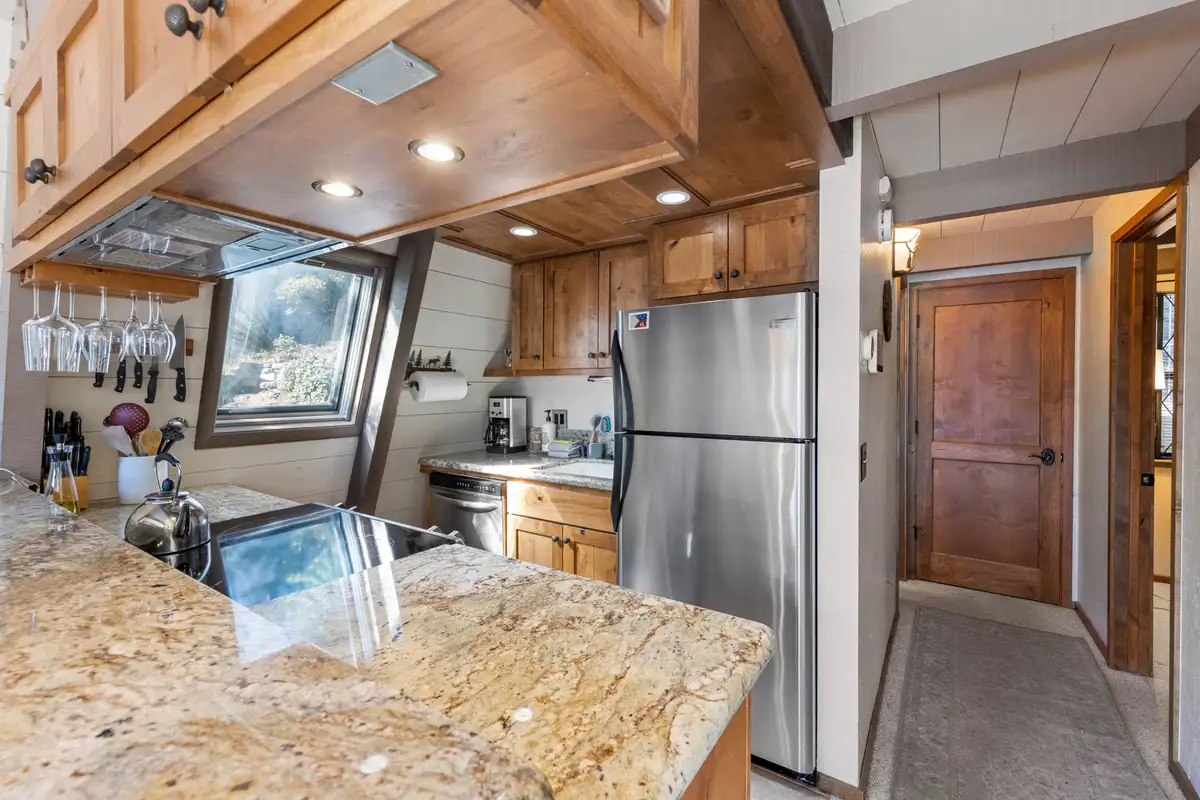 Kitchen with granite counters and stainless refrigerator, Livin' on the Edge