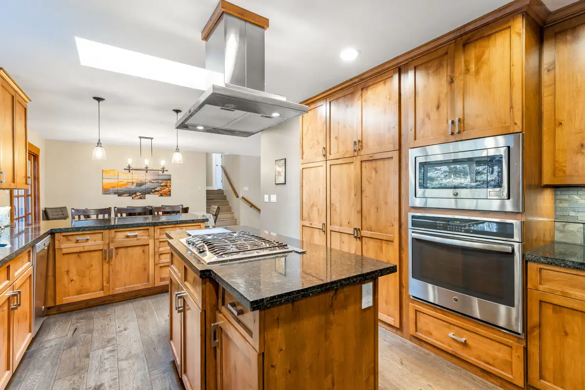 Kitchen with wood cabinets, wall ovens and an island, Tranquil Stay