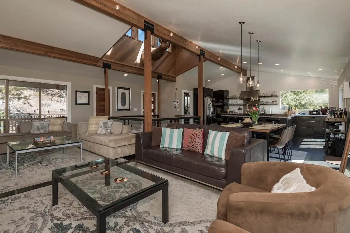 Open living area with a leather sofa and kitchen beyond, Skylake Serenity Retreat