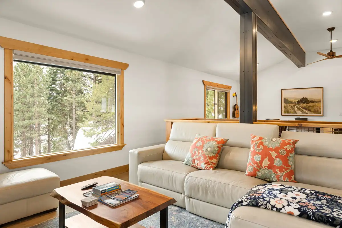 Living room with sectional and large forest-view window, Sugar Pine Tahoe Lodge