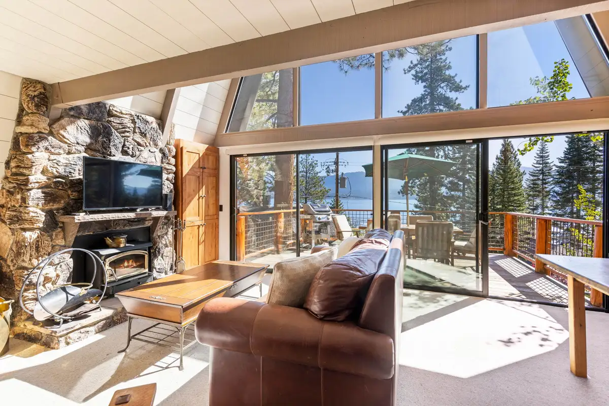 A-frame living room with stone fireplace and lake view, Livin' on the Edge