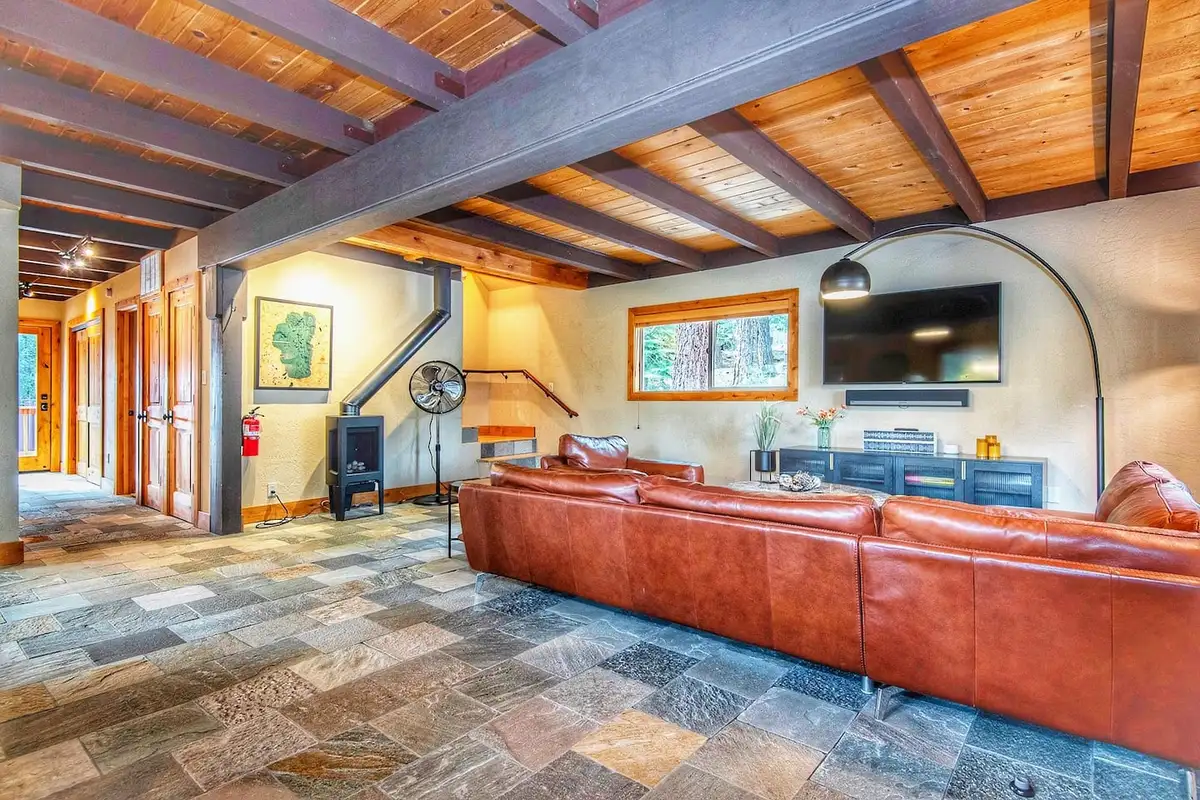 Living room with leather sectional and wood stove, Restful North Ridge