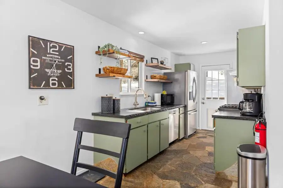 Galley kitchen with green cabinets and open shelving, Mountaintop Retreat