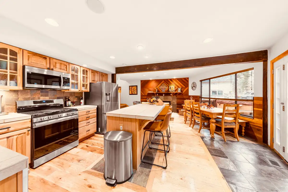 Kitchen with island and dining area beyond, Sunlit Incline Retreat