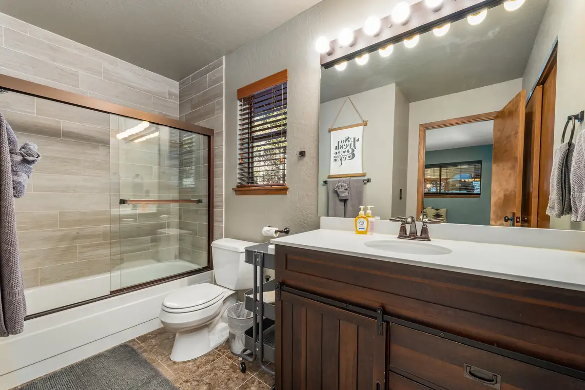 Bathroom with a shower-tub and wood vanity, Grand Regency Retreat