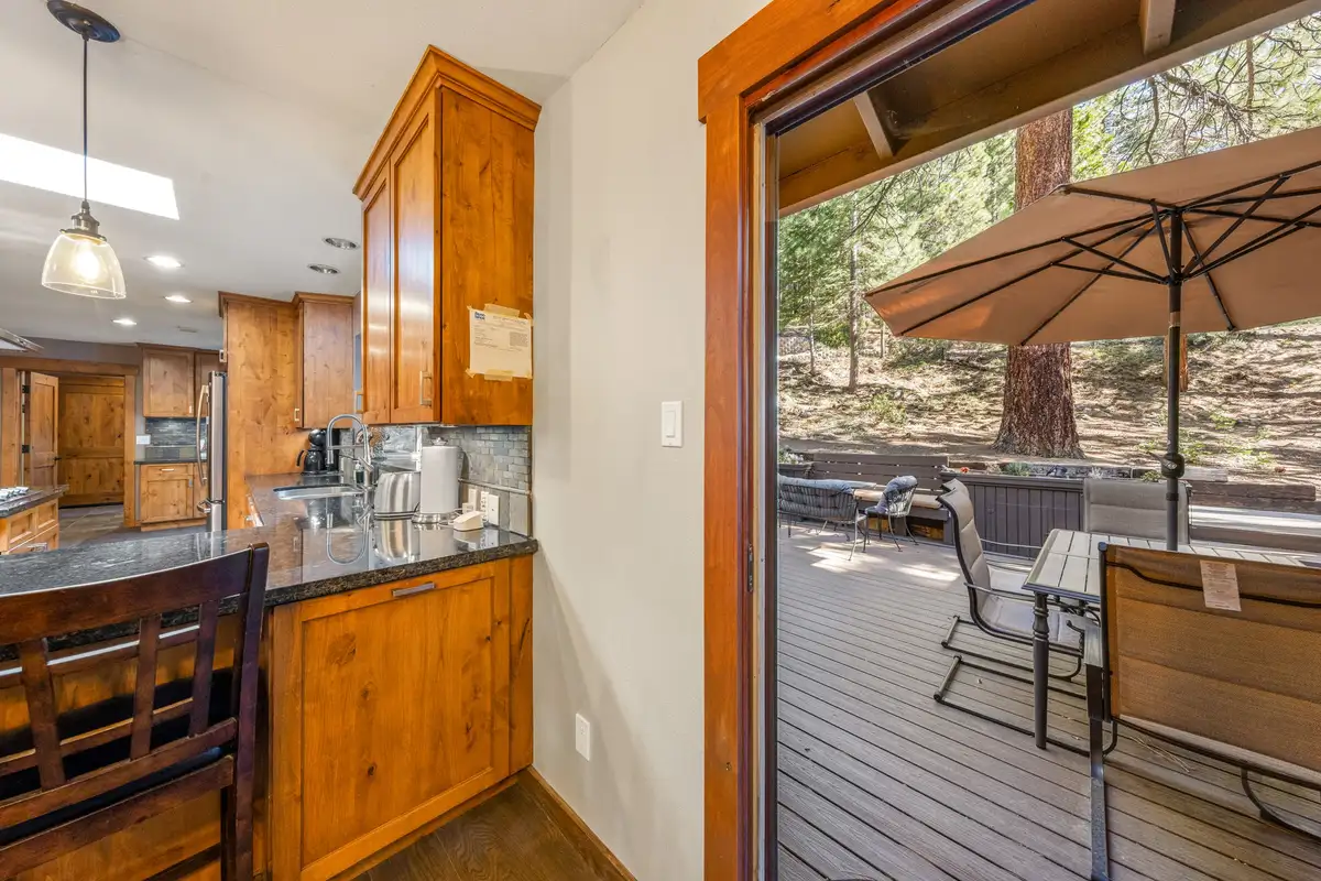 Kitchen with a sliding door open to a deck with umbrella, Tranquil Stay