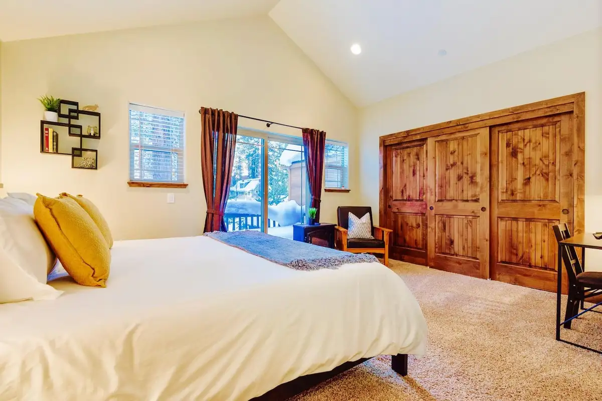 Bedroom with vaulted ceiling and wood closet doors, Trout and About
