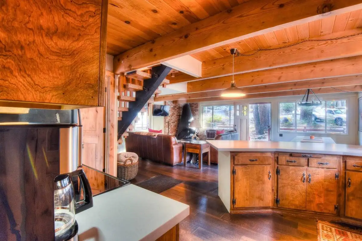 Kitchen with wood cabinets opening to the living area, Enchanting Chamberlands Cabin