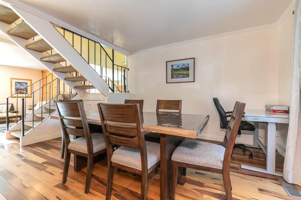 Dining table beneath an open staircase, Trailside Tahoe Townhouse