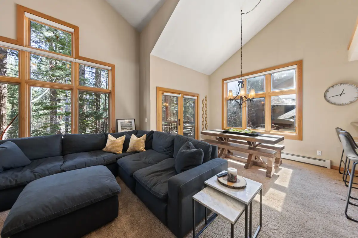 Living room with large sectional and tall windows, Elevated Tahoe Escape