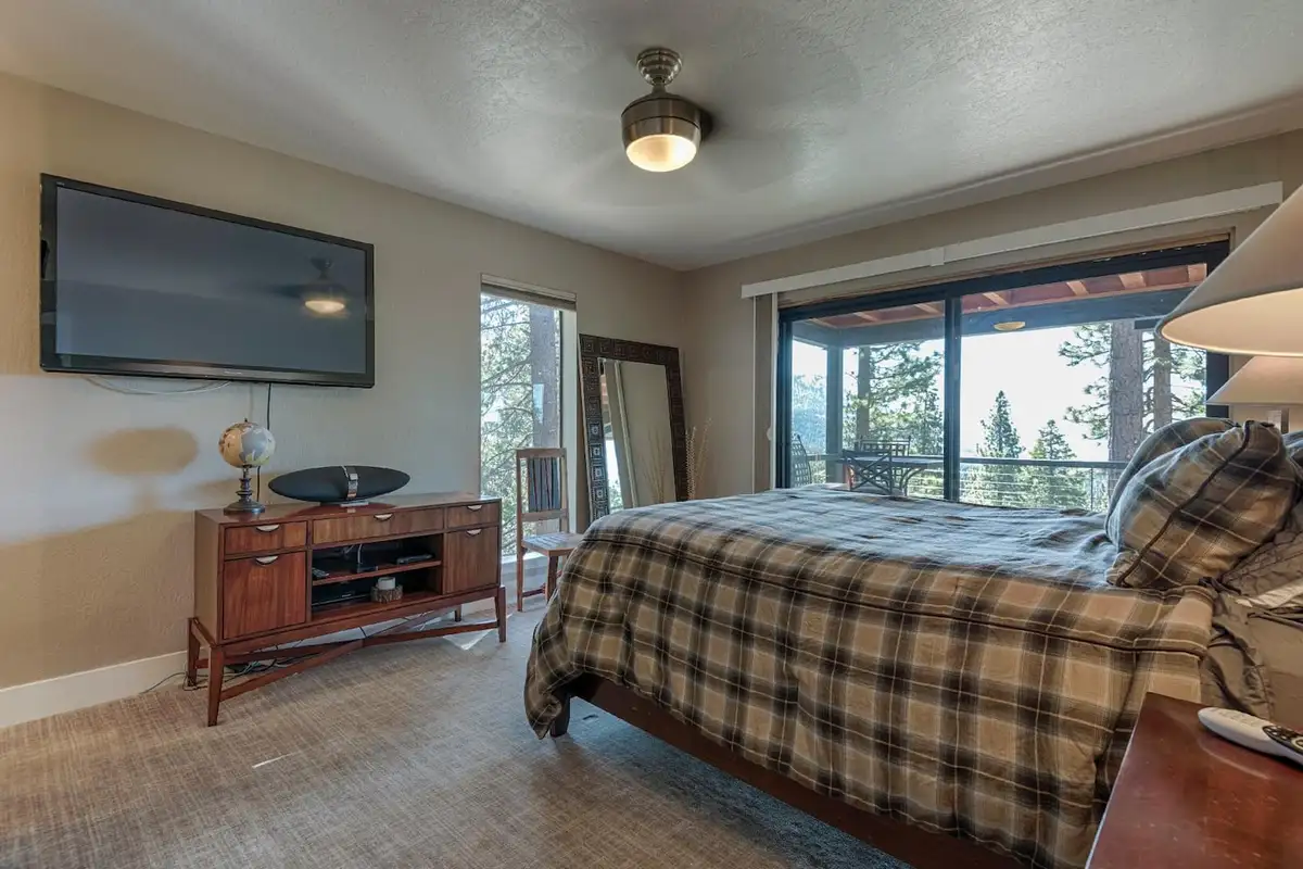 Bedroom with plaid bedding, wall TV and sliding doors to a deck, Skylake Serenity Retreat