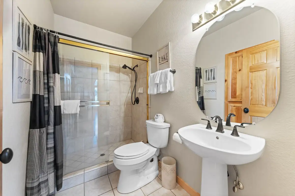 Bathroom with pedestal sink and glass shower, Lakeview Grandeur
