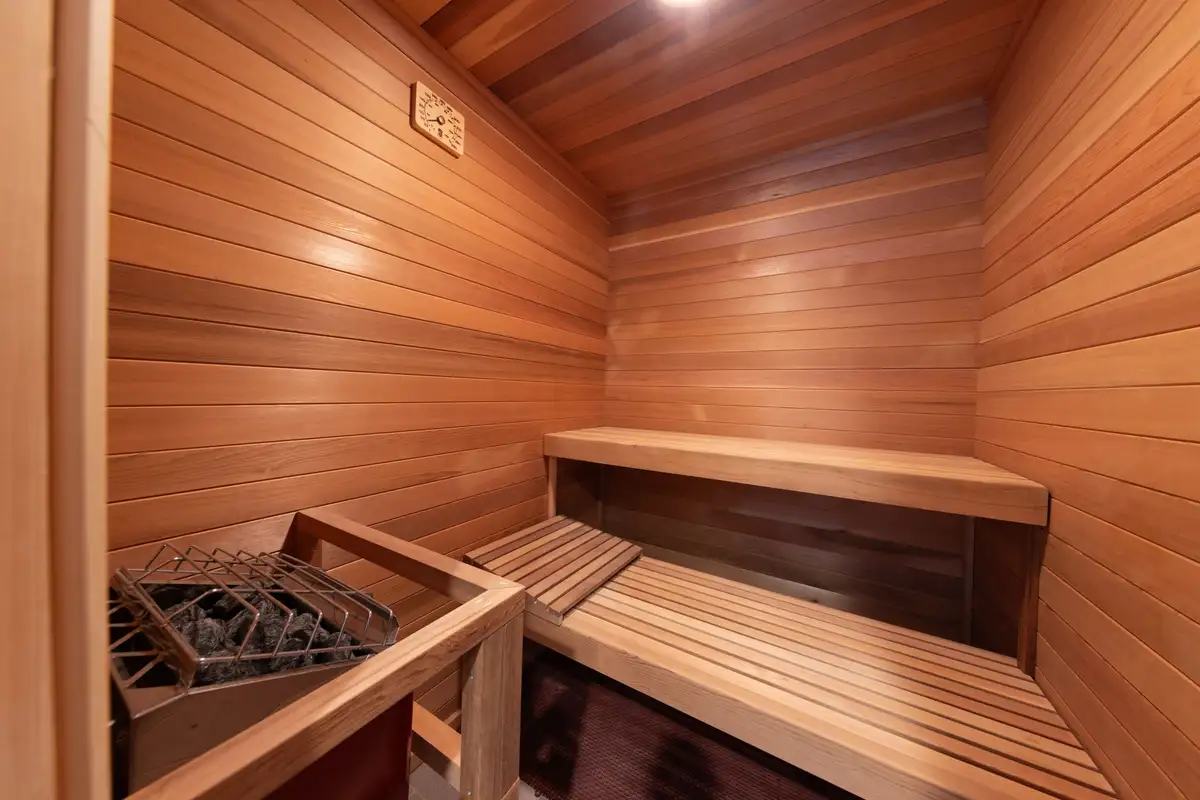 Cedar-lined sauna with wood benches and heater, 90s Tahoe Time Capsule