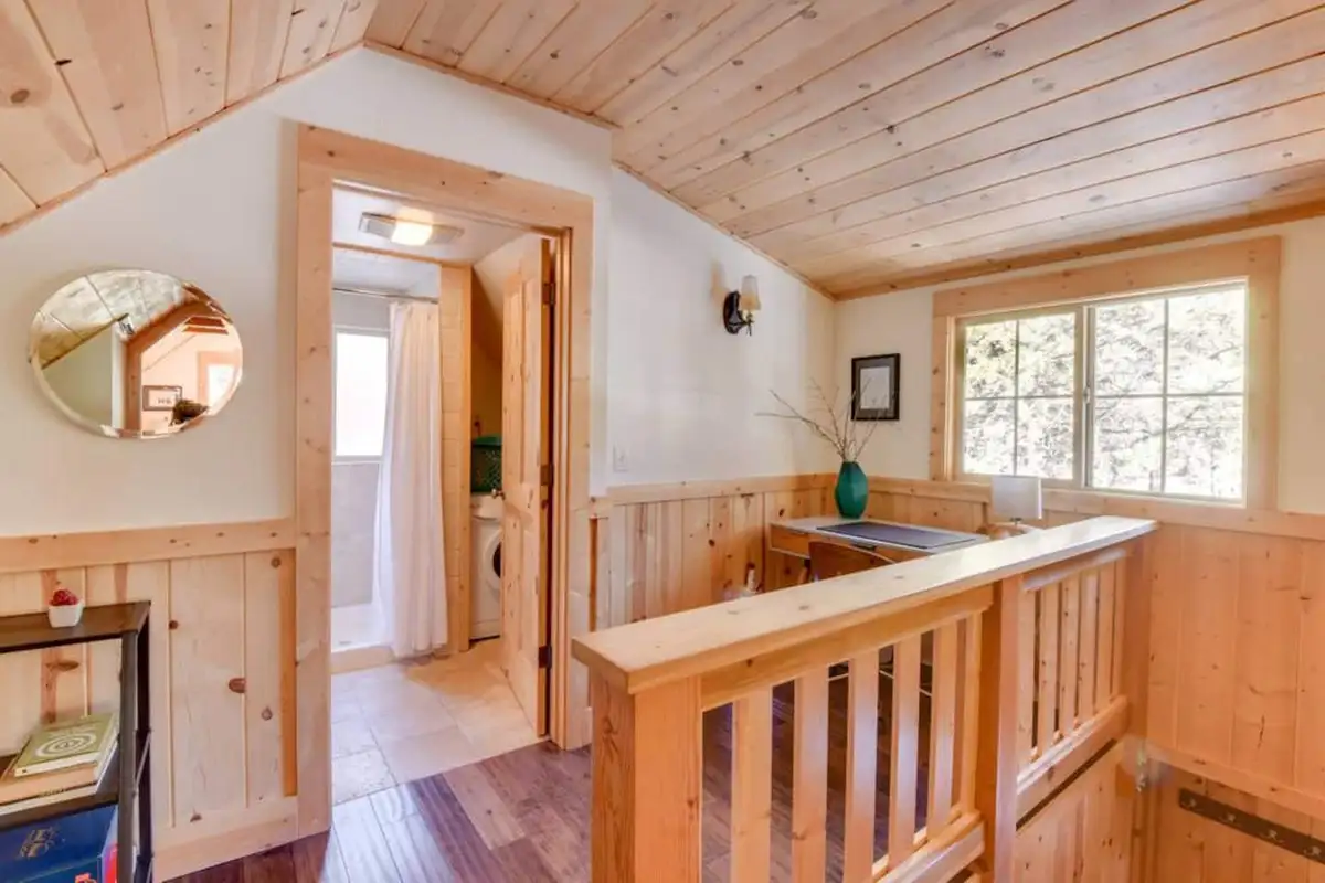 Upstairs landing with pine railing and wood ceiling, Tranquil Trails Cabin