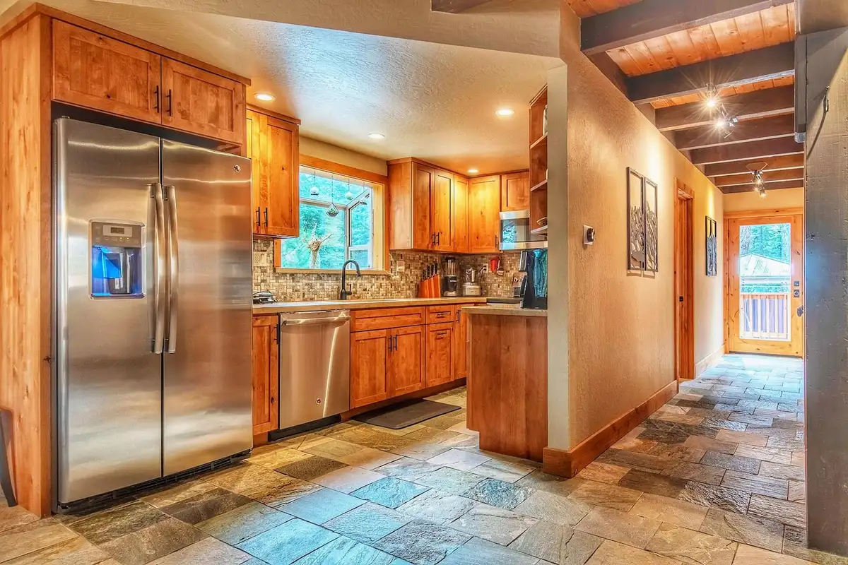 Kitchen with stainless refrigerator and slate tile floor, Restful North Ridge