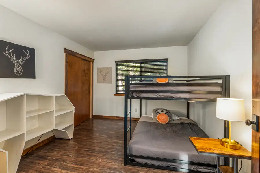 Bedroom with a metal bunk bed and shelves, Grand Regency Retreat