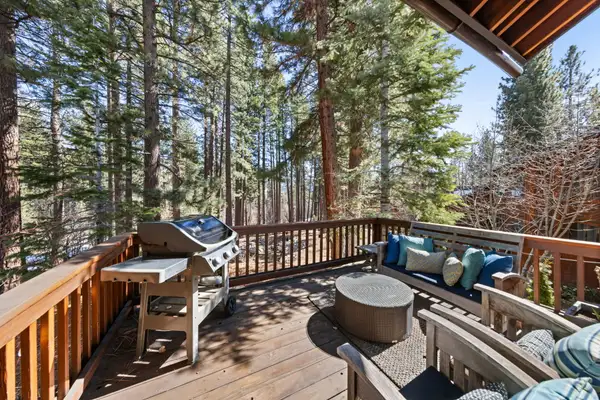 Deck with a grill and outdoor seating among tall pines, Elevated Tahoe Escape