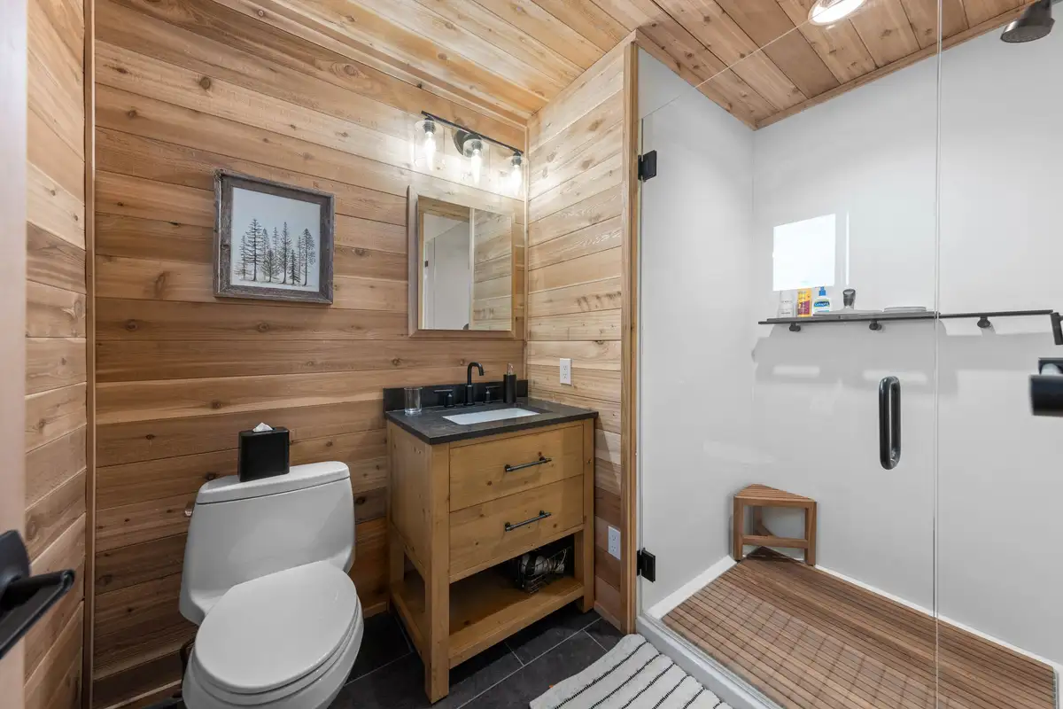 Bathroom with wood walls, vanity and glass shower, Updated West Shore Cabin 1 mile to Chambers Beach