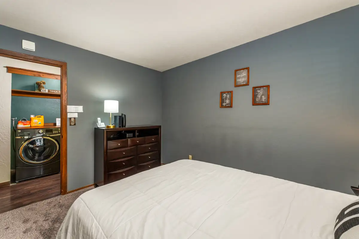 Bedroom with a bed and view into a laundry area, Grand Regency Retreat
